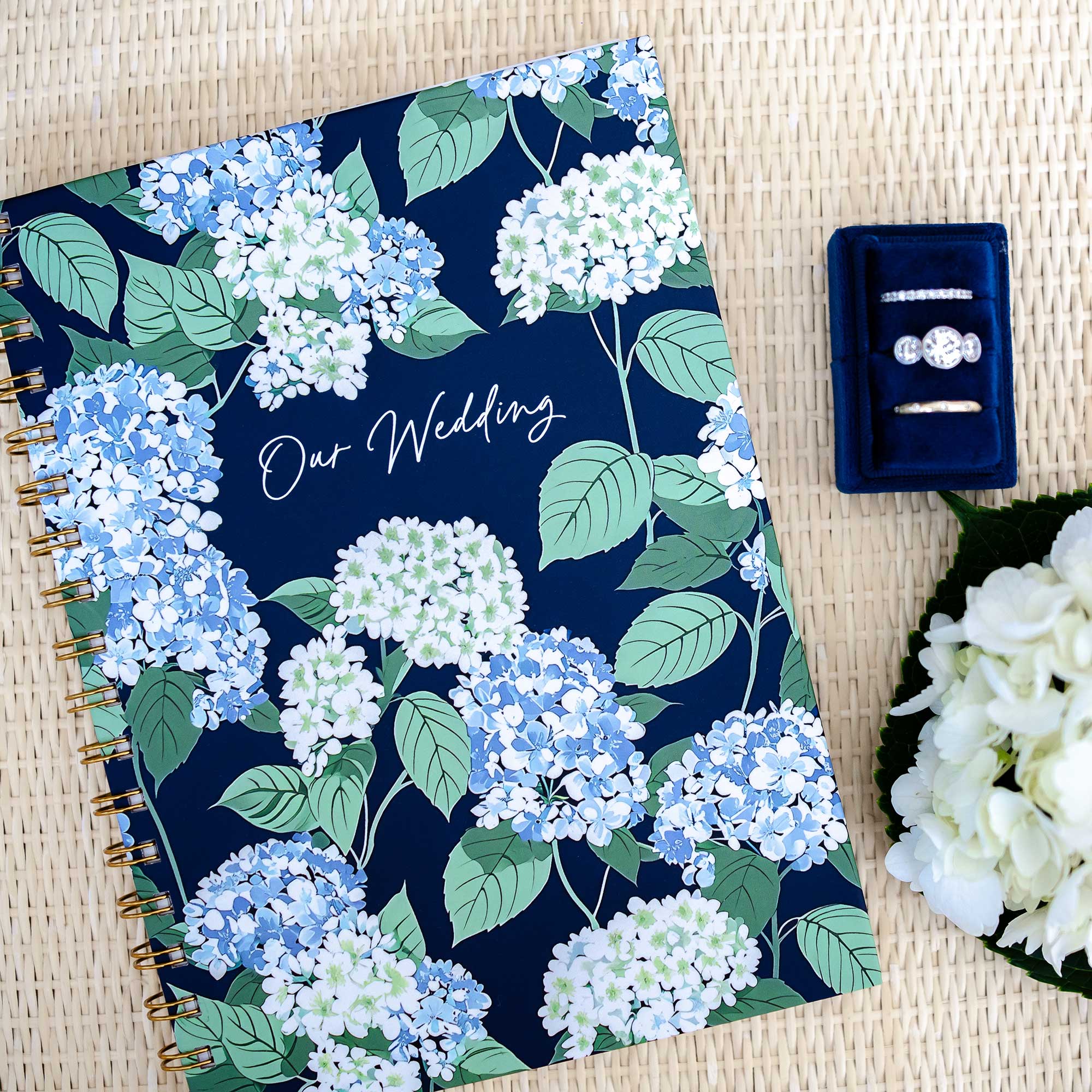 Flat lay of Keepsake Paper Co. bestselling wedding planners in cape hydrangea cover design