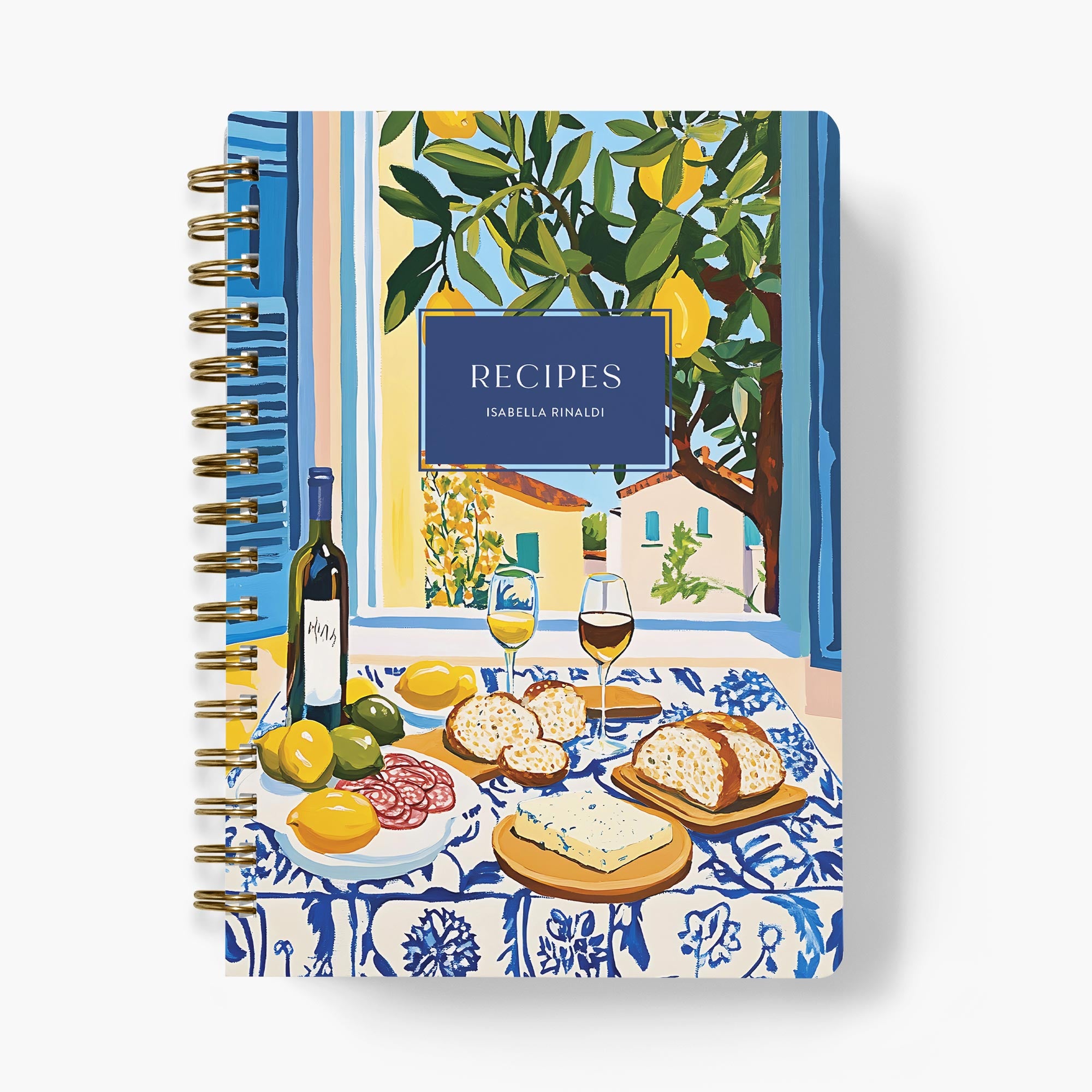 Custom recipe book with a cover design of an alfresco dining table outdoors, featuring food and drinks.