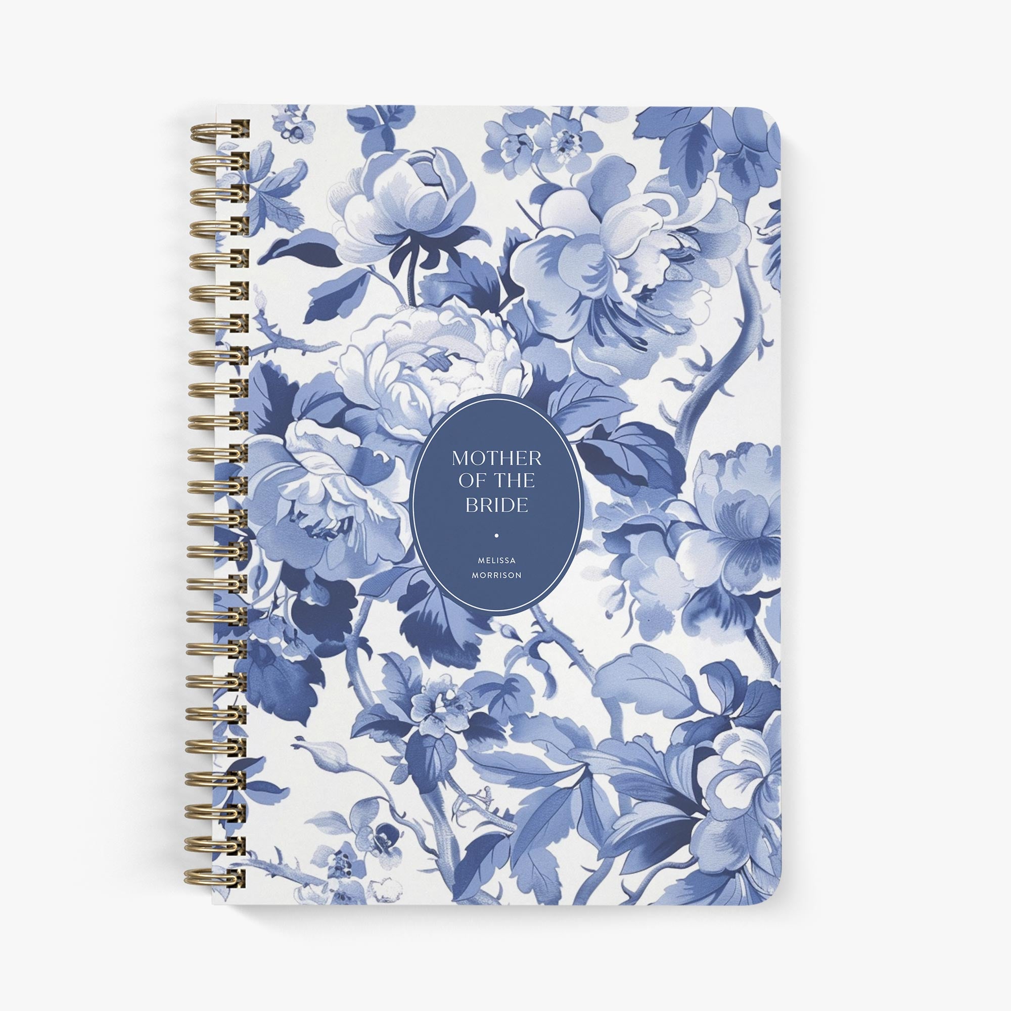 Mother of the bride planner with blue and white toile pattern cover on a white background