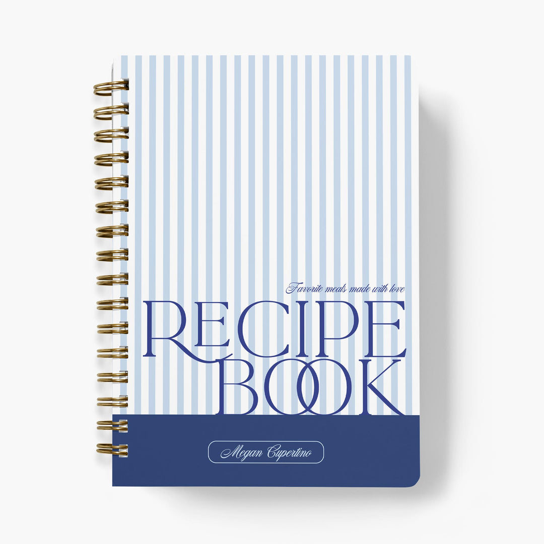 Custom recipe journal with a classic stripe design in blue and white, paired with bold text and bound with gold wire