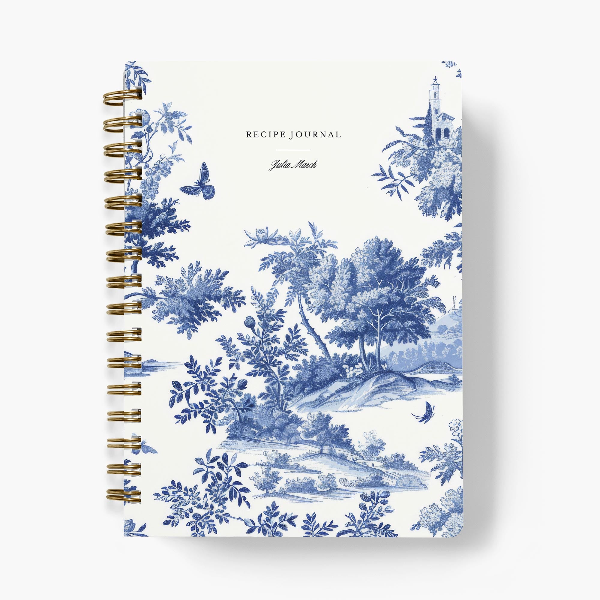 Custom recipe journal with blue and white toile pattern on a white background with gold wire binding