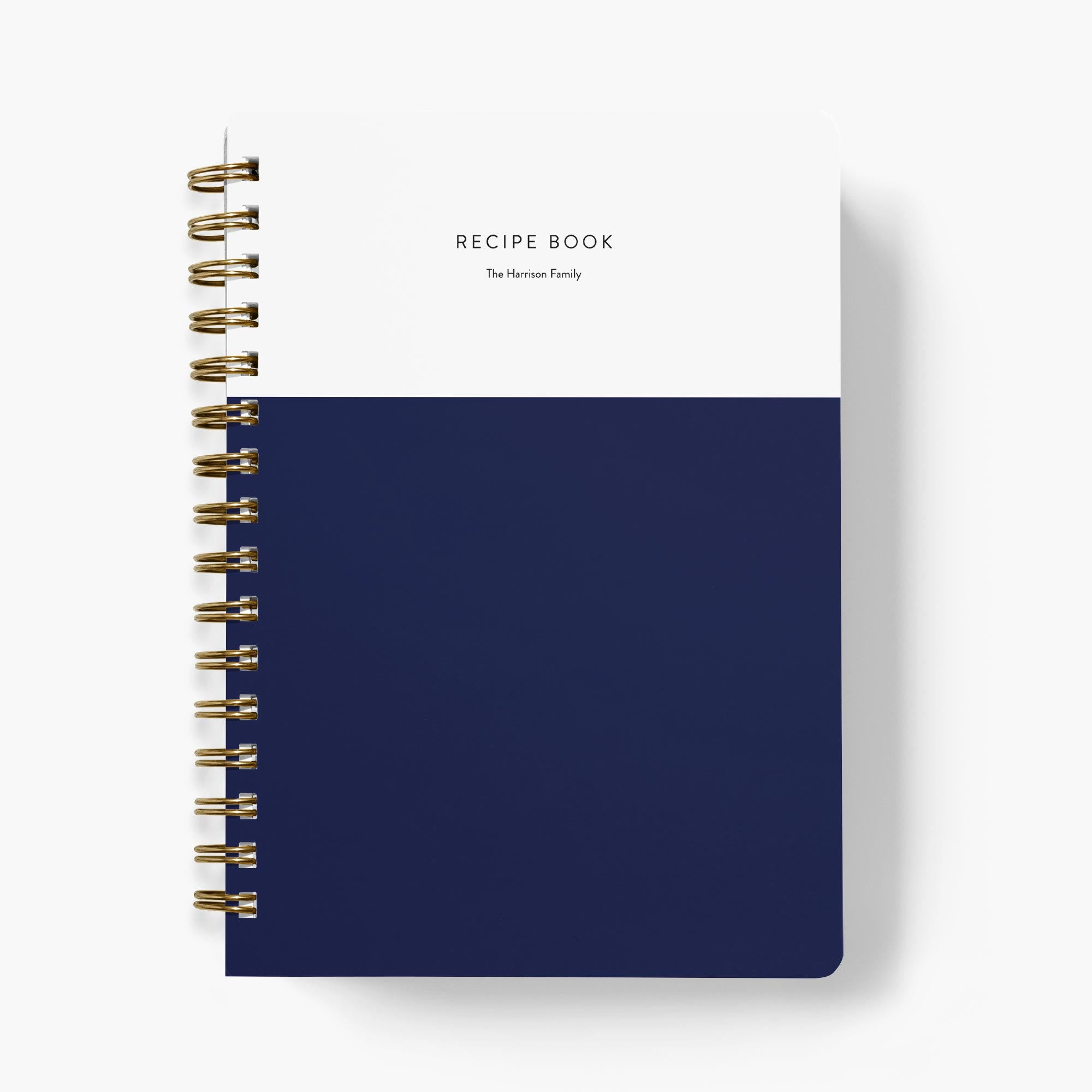 Custom colorblock recipe book with white top half and navy bottom half on a white background