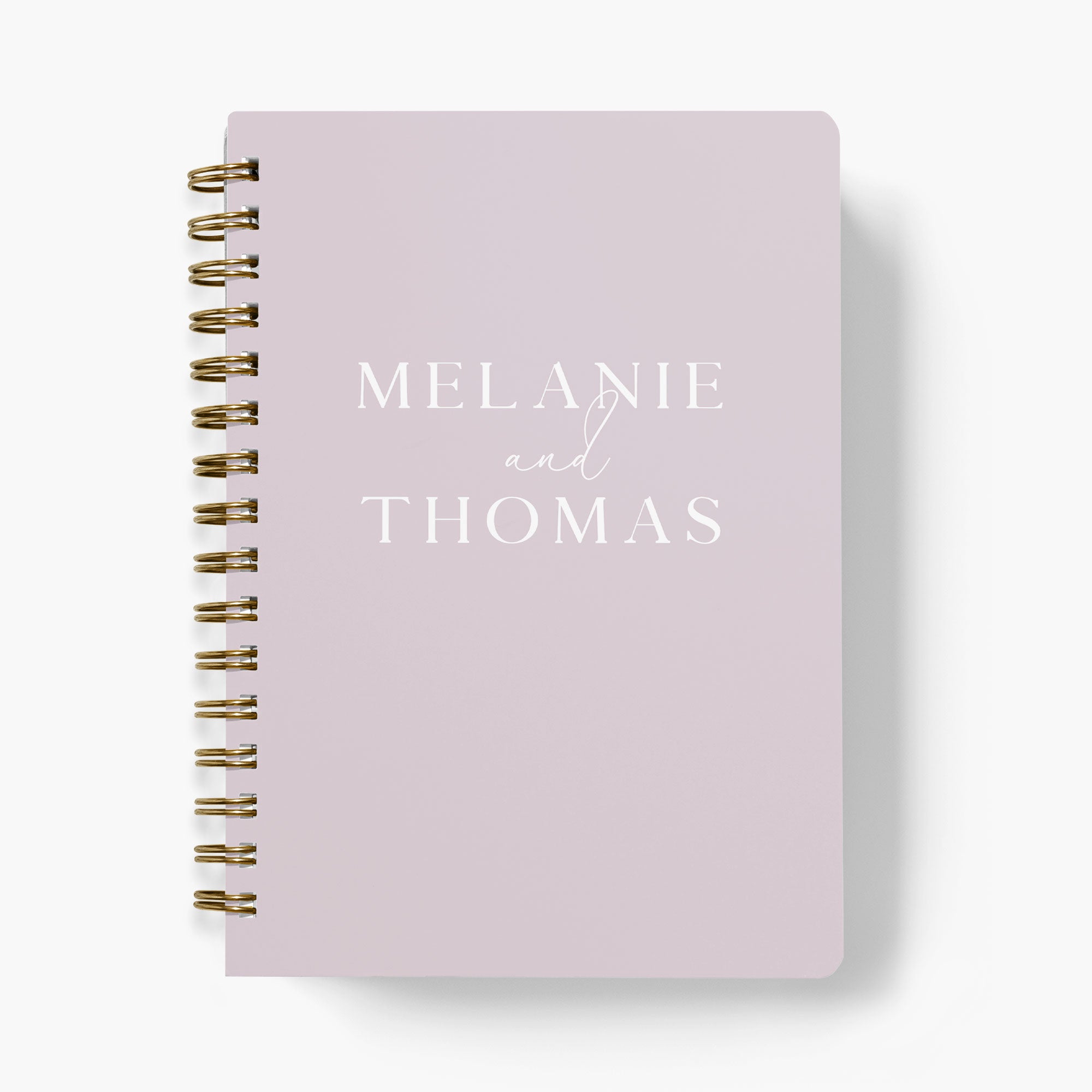 Personalized wedding planner with the bride and groom's names on the cover on a white background
