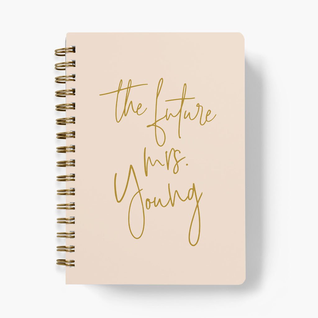 Personalized wedding planner with 'the future mrs.' text on a blush pink background