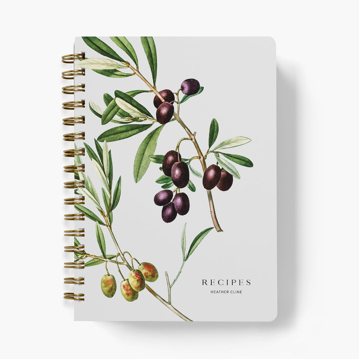 Custom cookbook with olive branch illustration on a white background