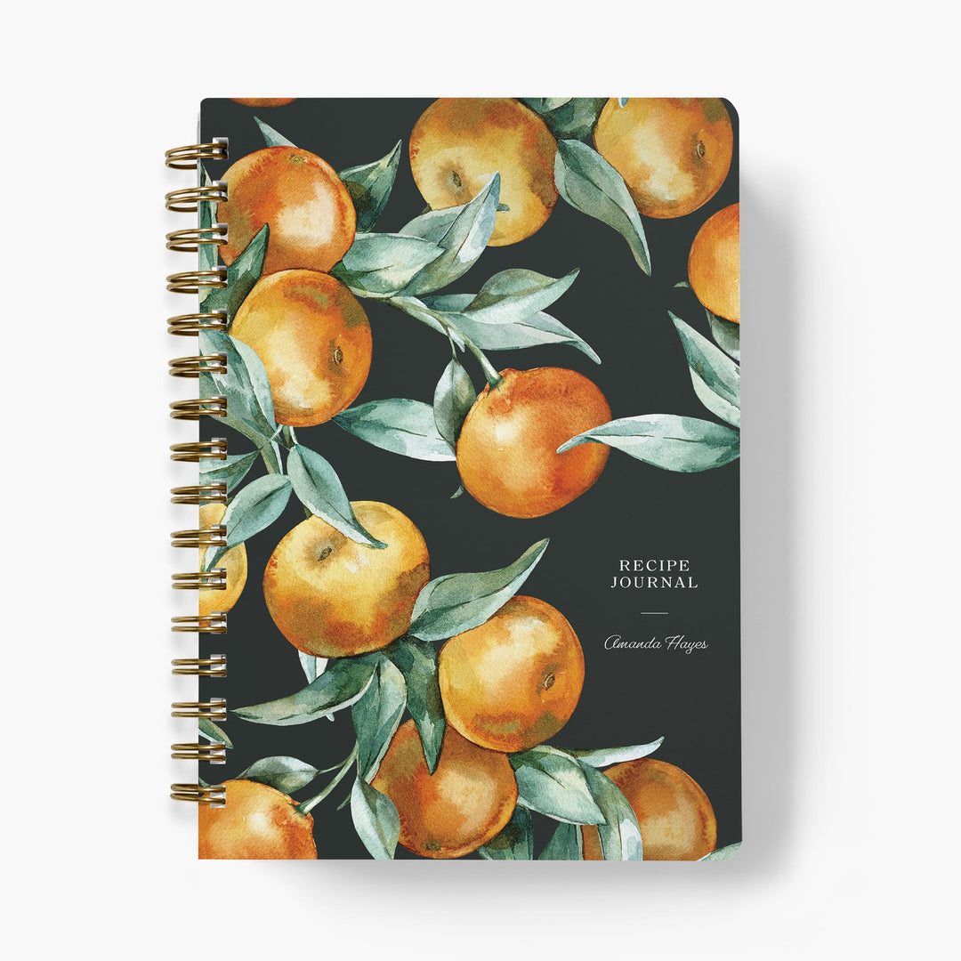 Custom recipe journal with watercolor oranges and leaves on a dark background