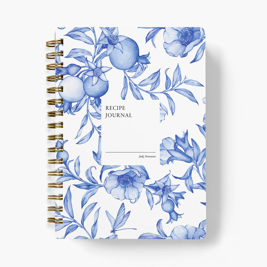 Custom recipe journal with blue and white floral design on a white background