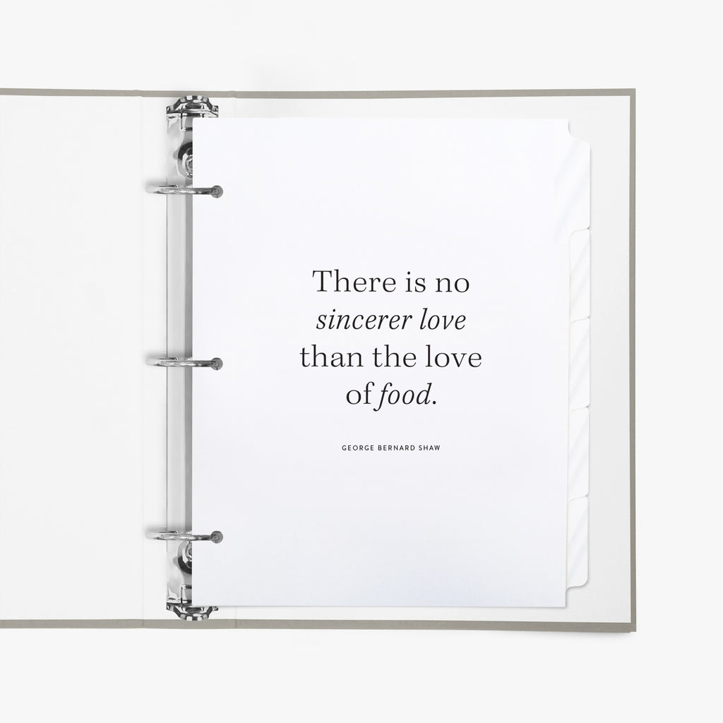 Open recipe binder featuring a set of divider tabs, the first shows a quote about  food, on a white background