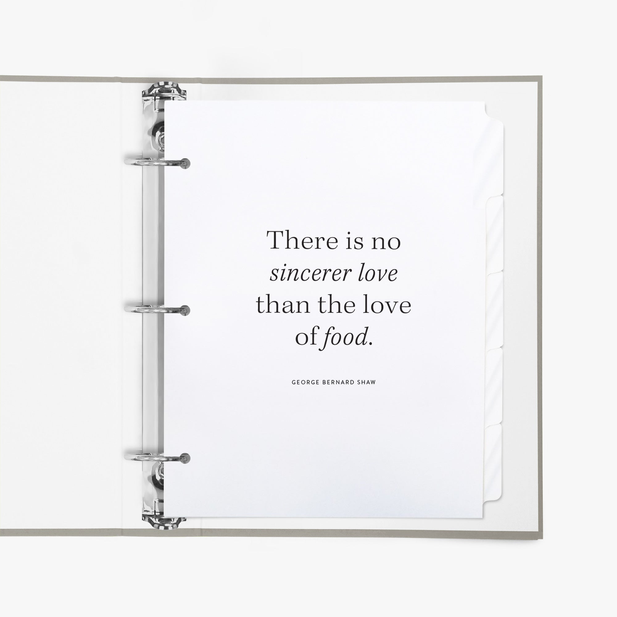 Open recipe binder featuring a set of divider tabs, the first shows a quote about  food, on a white background