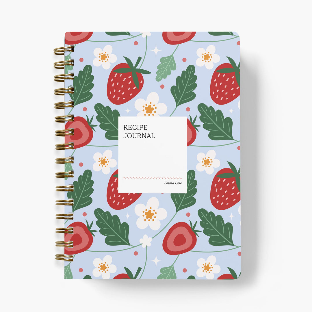 Custom recipe journal with strawberry and floral pattern on a light blue background