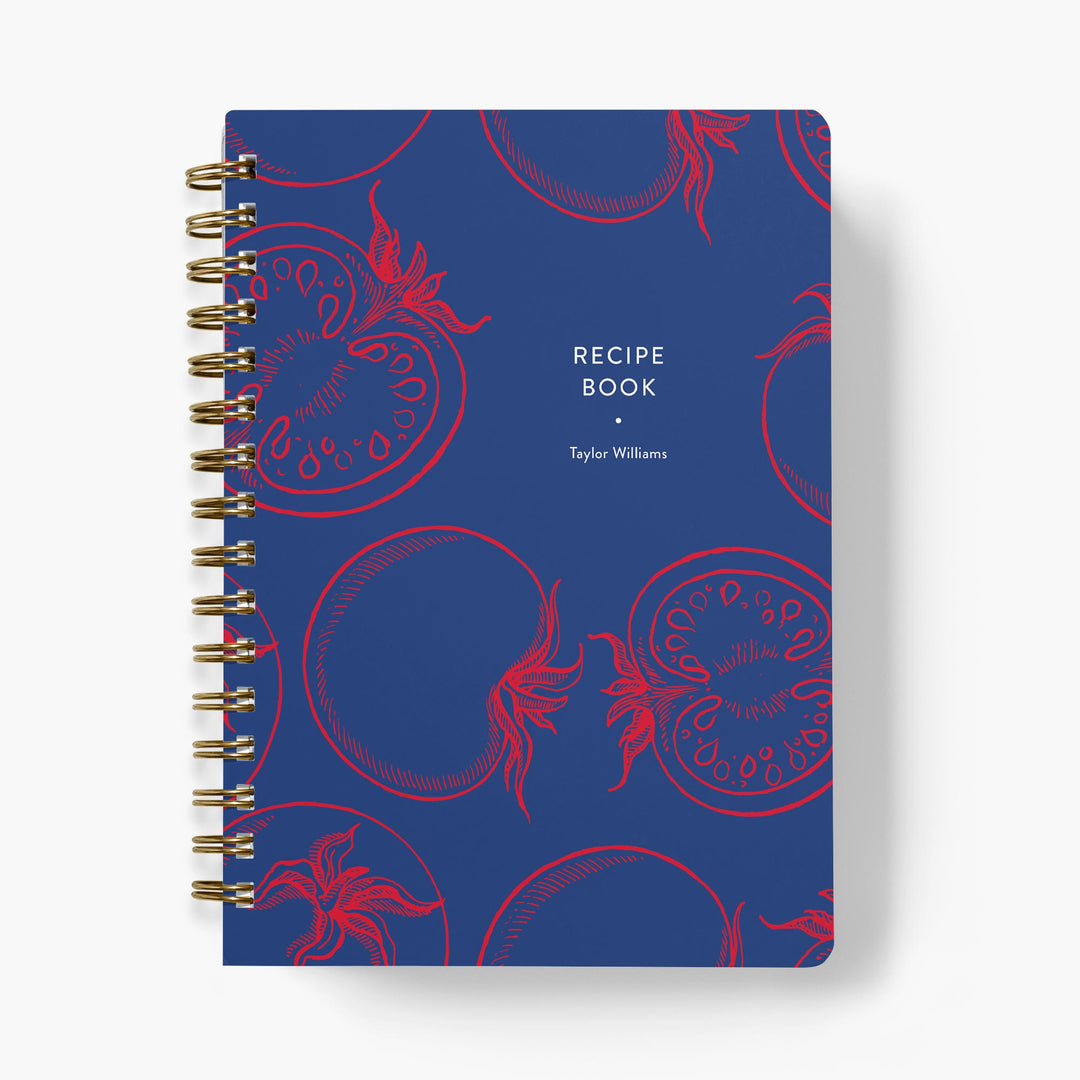 Custom recipe book with red tomato illustrations on a navy background