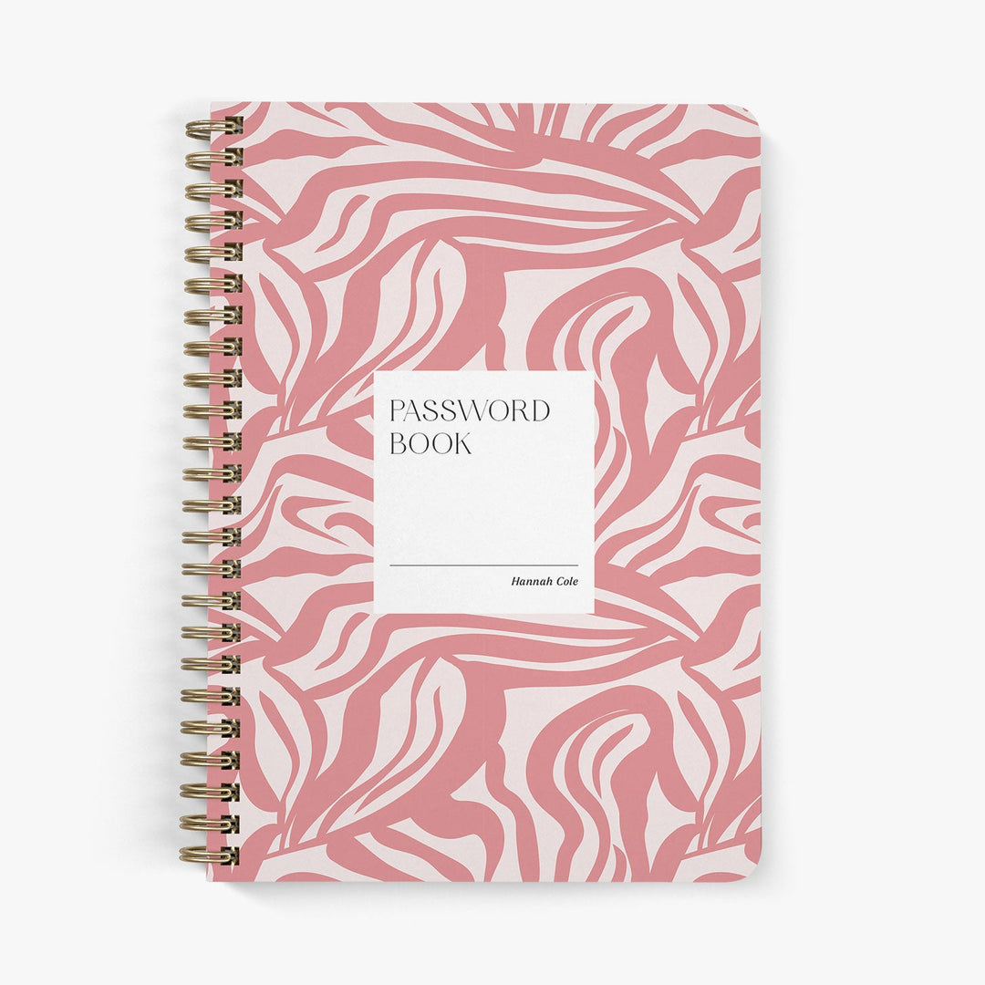 Custom password book featuring a modern abstract pattern in coral pink with brass wire binding