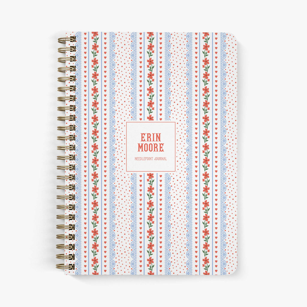 Custom needlepoint journal with Americana-inspired floral pattern with hearts on a white background