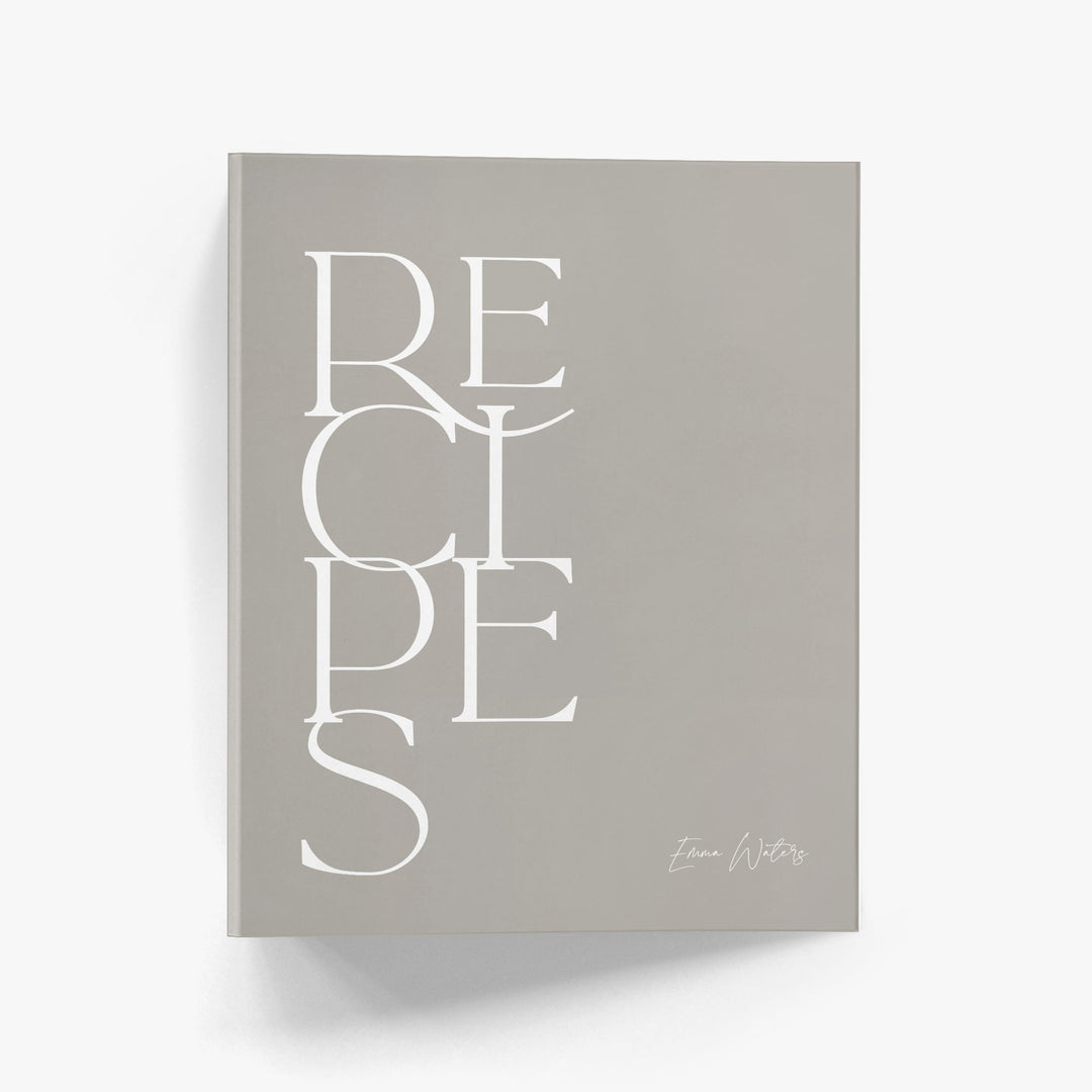 Custom recipe binder in a modern minimalist design featuring bold text in neutral white and beige