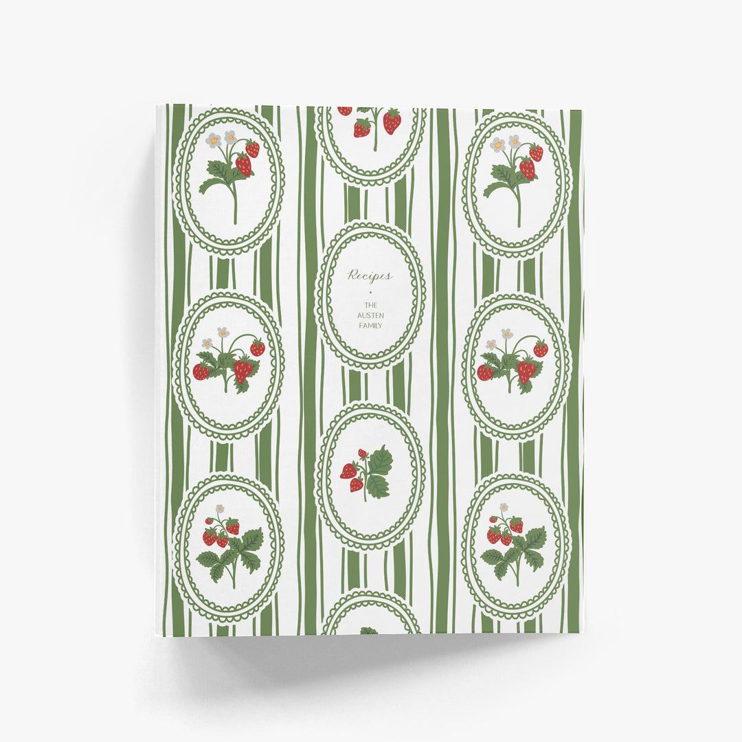 Custom cookbook with green and white striped design and strawberry illustrations on a white background