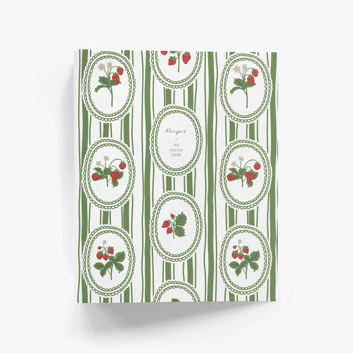 Custom cookbook with green and white striped design and strawberry illustrations on a white background