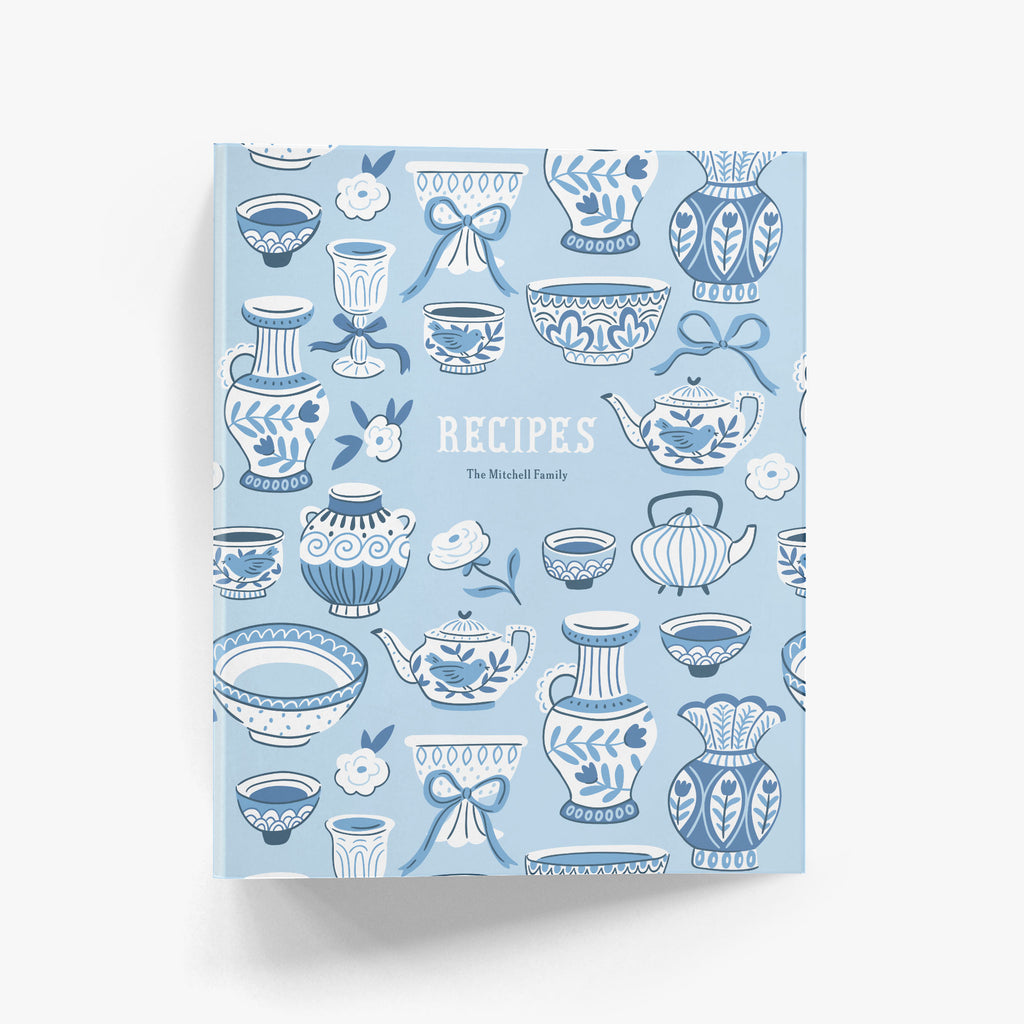 Custom recipe binder in a cheerful pattern of teapots and teapots in a fresh blue and white chinoiserie style on a white background.