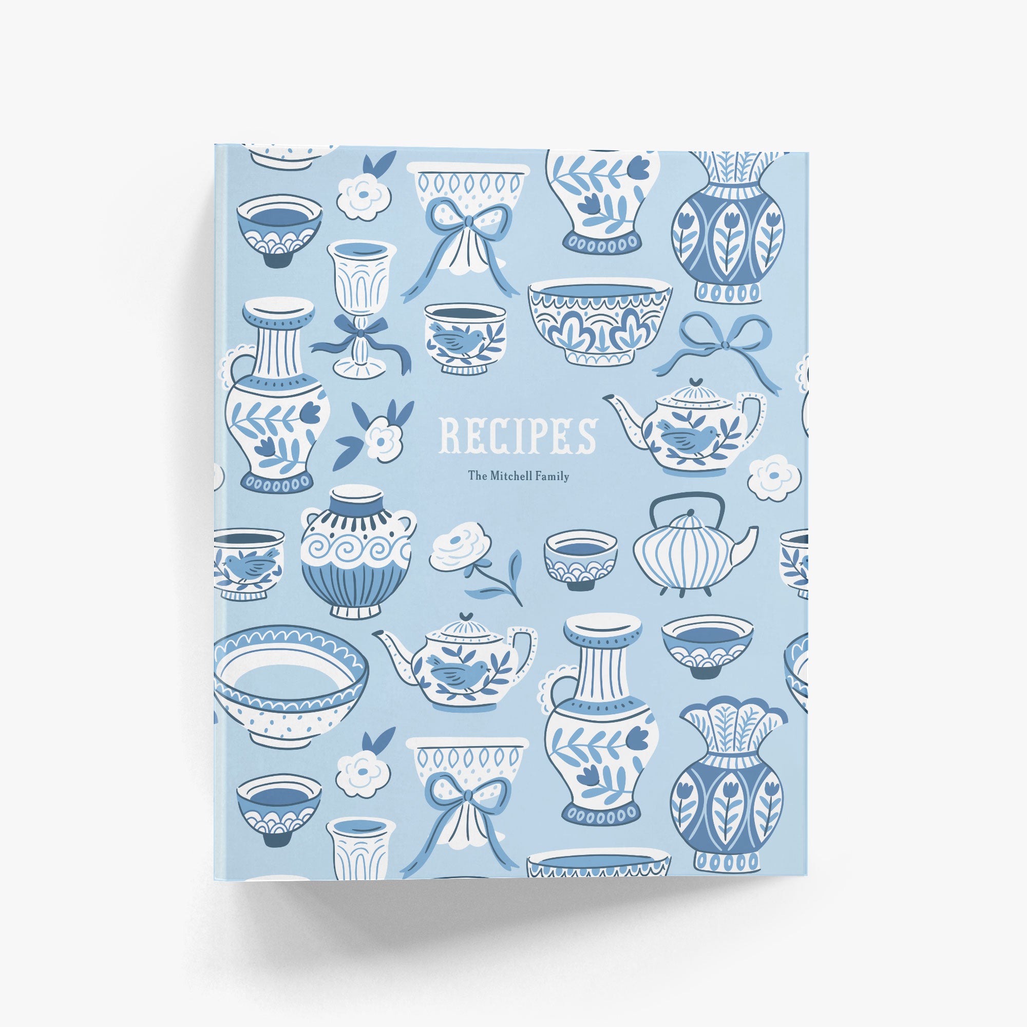 Custom recipe binder in a cheerful pattern of teapots and teapots in a fresh blue and white chinoiserie style on a white background.