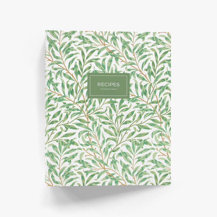 Personalized recipe binder in art-deco inspired green and white willow pattern on a white background