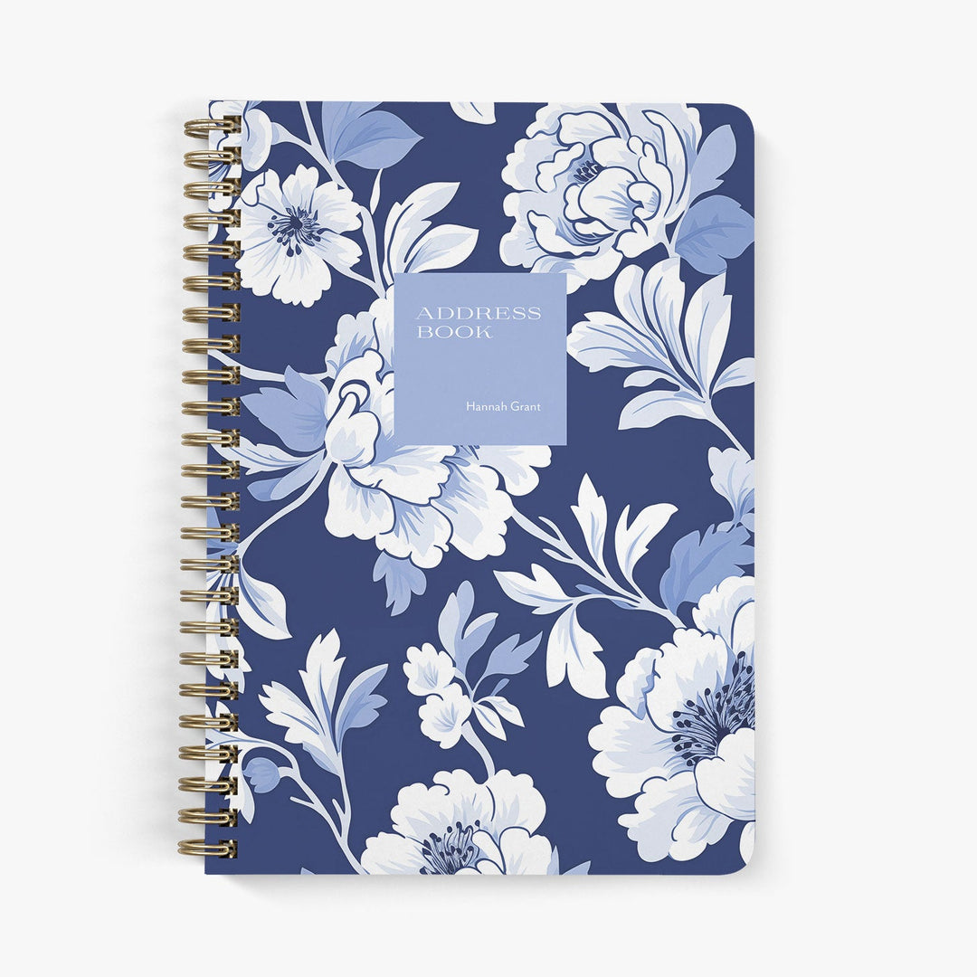 Custom address book with blue and white peony floral design on a white background