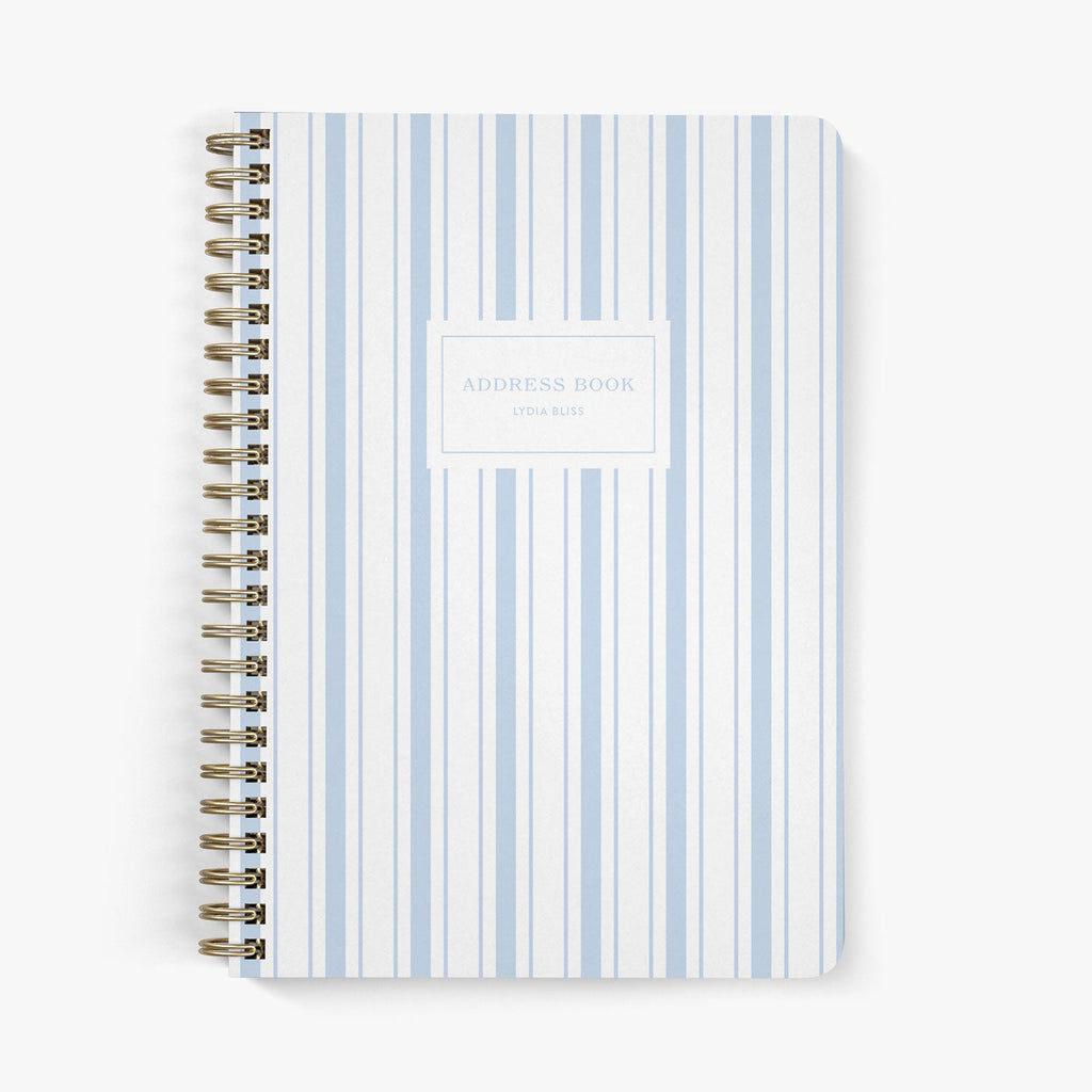 Address book with a nautically-inspired blue and white striped cover on a white background