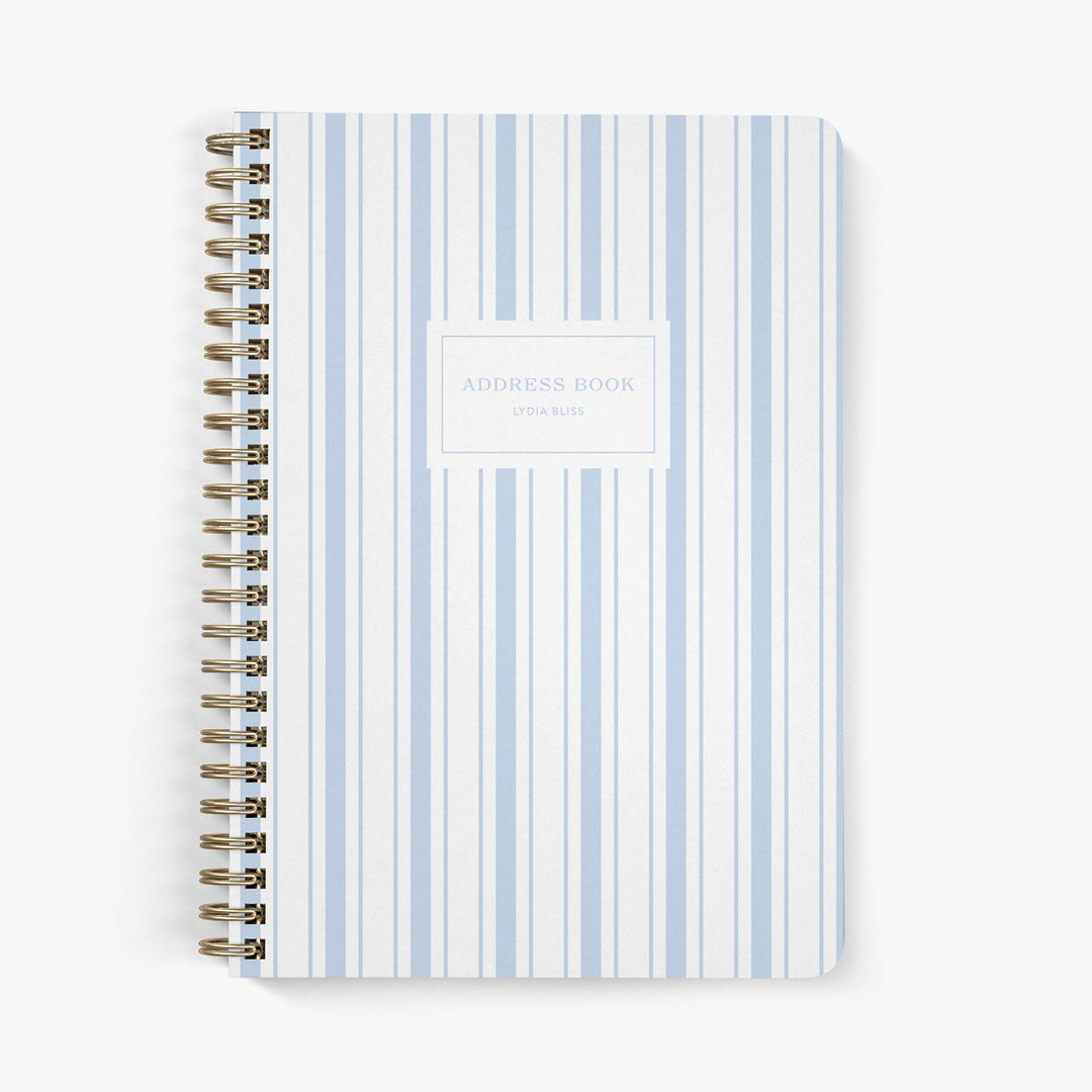 Address book with a nautically-inspired blue and white striped cover on a white background
