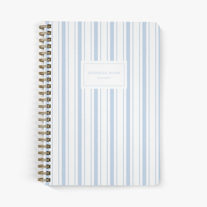 Address book with a nautically-inspired blue and white striped cover on a white background