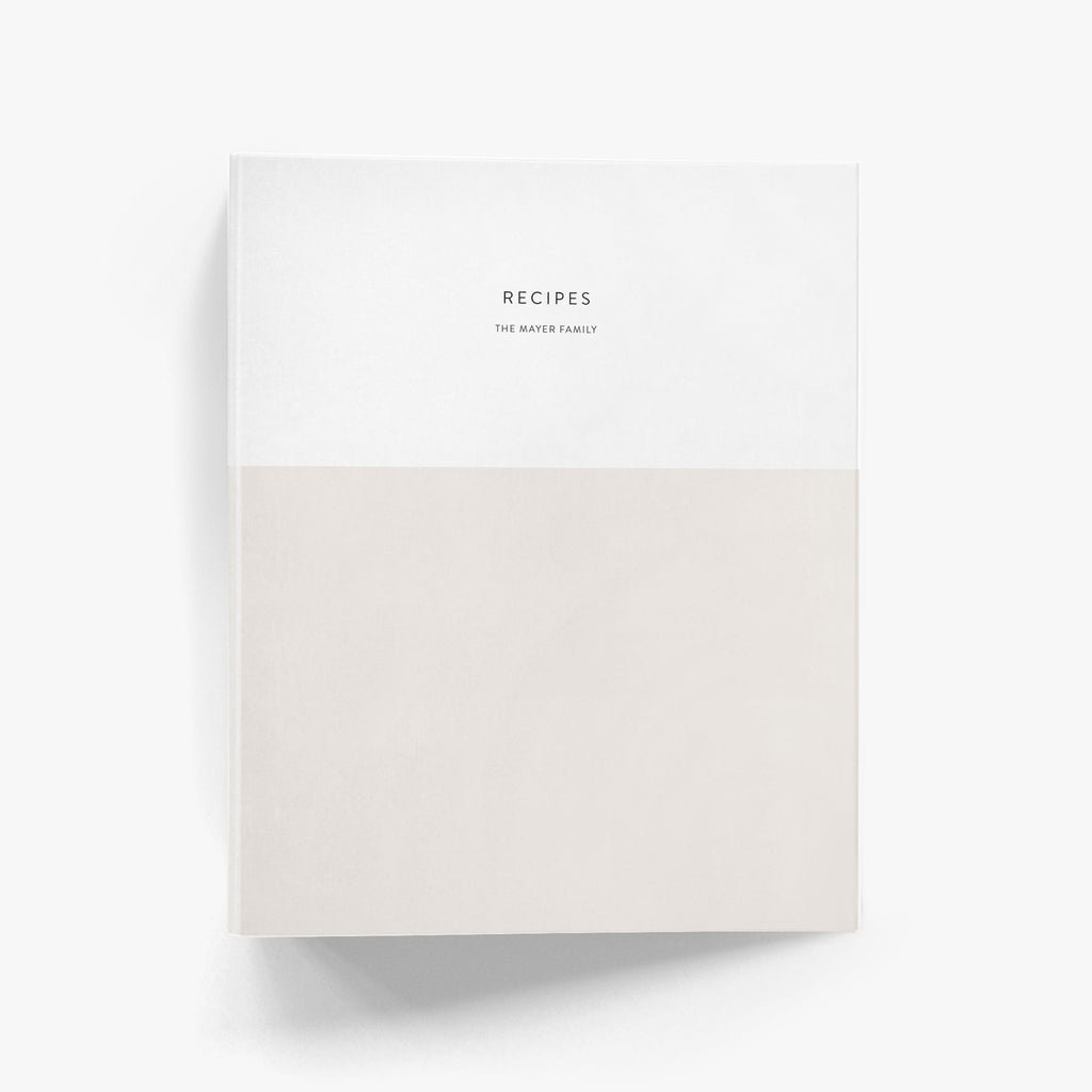 Custom recipe binder with a modern color block design shown in beige and white and personalized with a family name