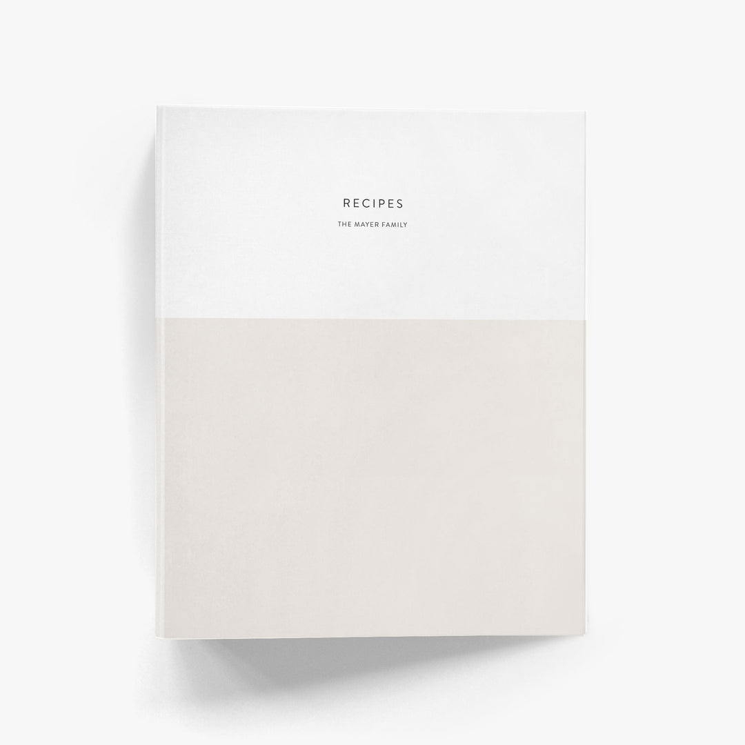Custom recipe binder with a modern color block design shown in beige and white and personalized with a family name