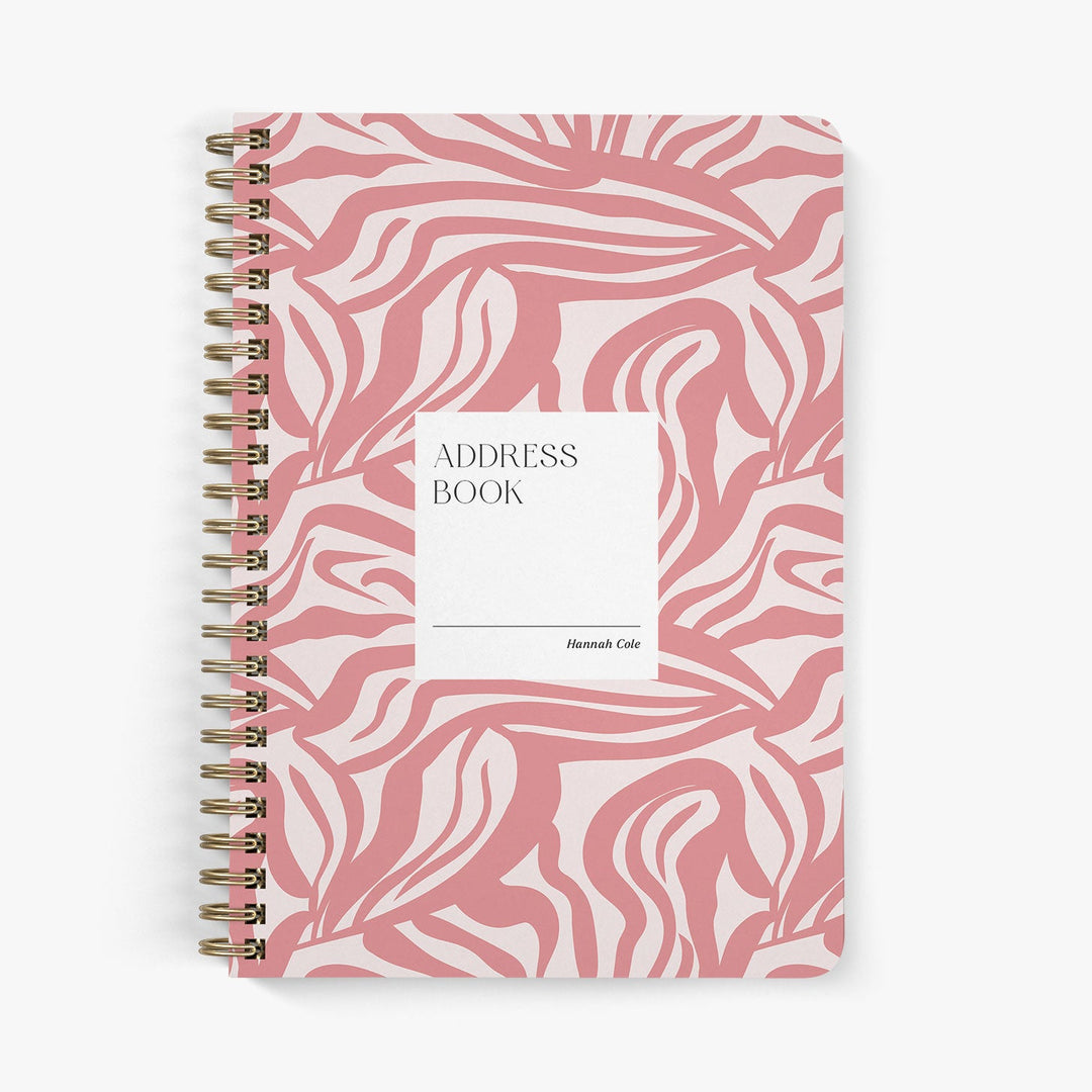 Custom address book with modern pink abstract pattern on a white background