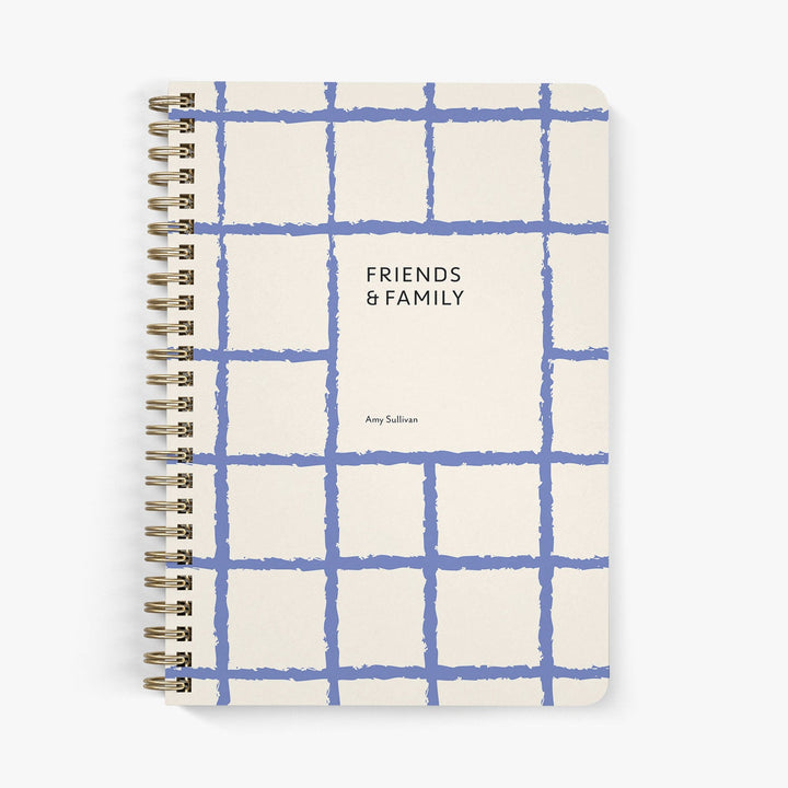 Address notebook with blue grid pattern and 'Friends & Family' text on a white background