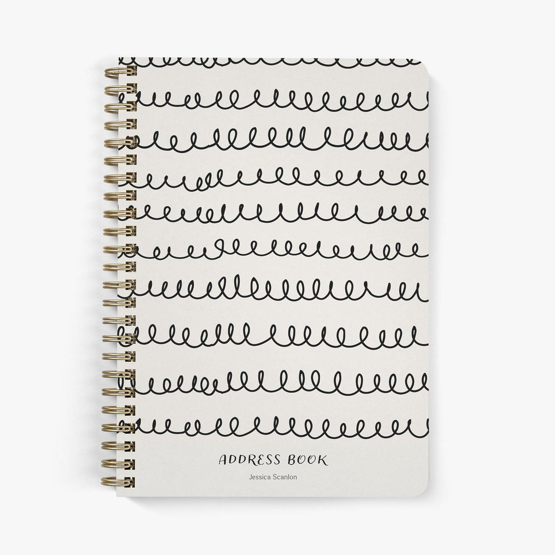 Custom address book with whimsical squiggle design in black on a beige cover
