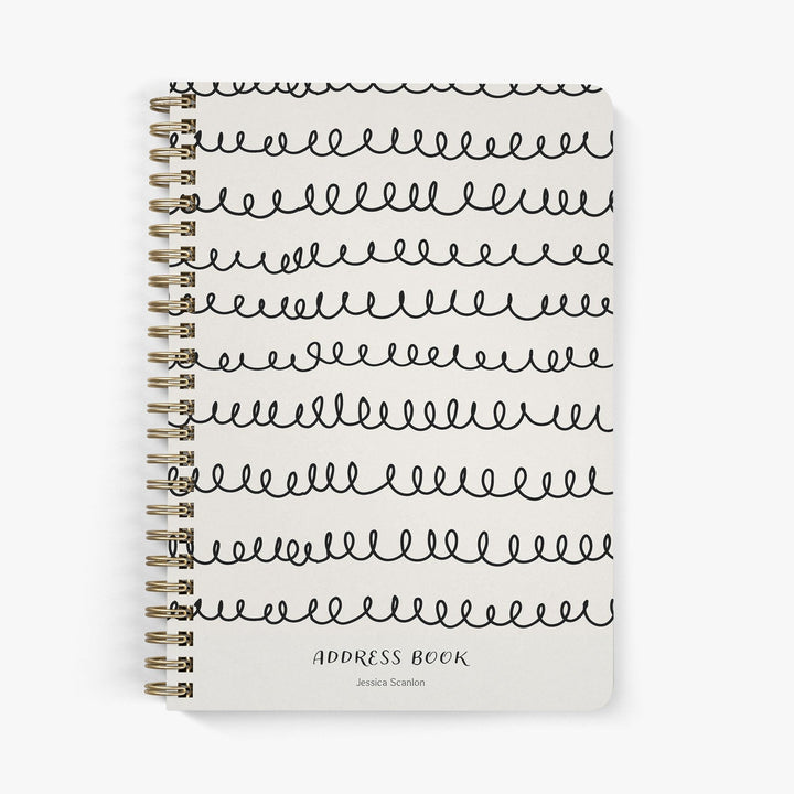 Custom address book with whimsical squiggle design in black on a beige cover