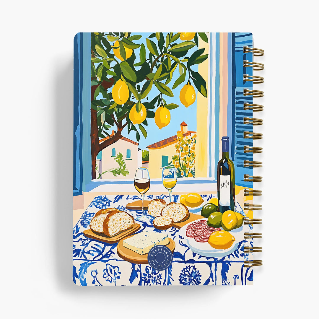 Personalized recipe notebook with a Mediterranean scene design on the cover, featuring lemons, wine, and food.