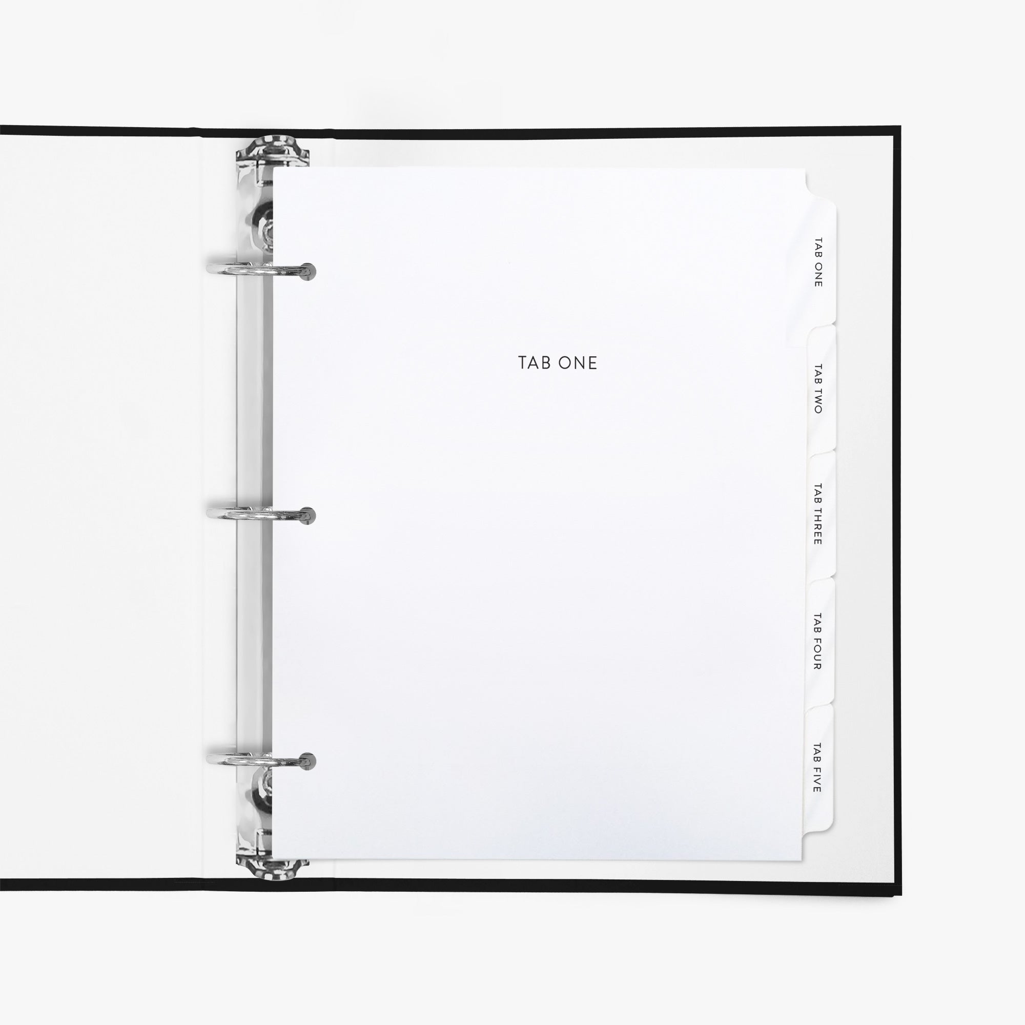 Custom white binder divider tabs with personalized section titles shown inside a standard 3-ring binder