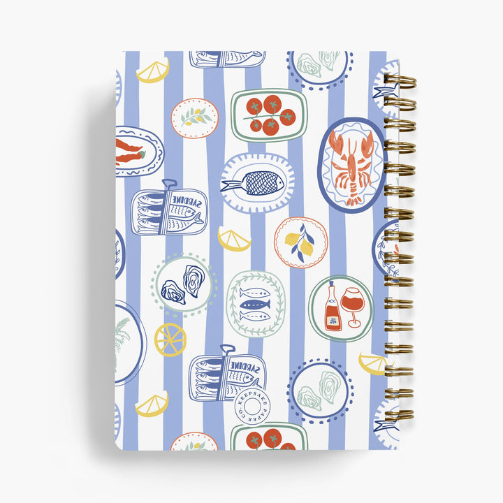 Personalized recipe notebook with a colorful food-themed design on blue and white striped background