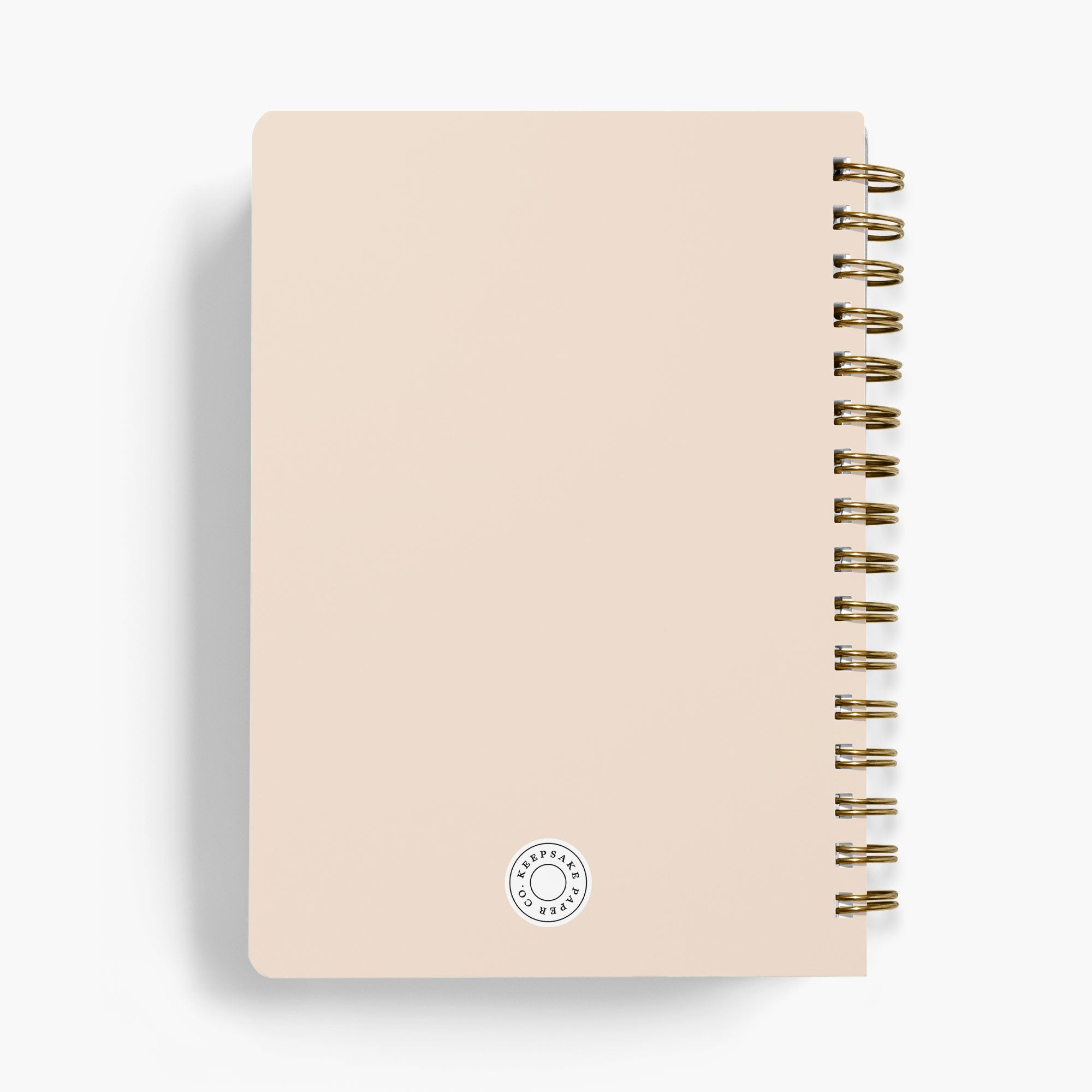 Back view of a wedding notebook with gold spiral binding on a white background