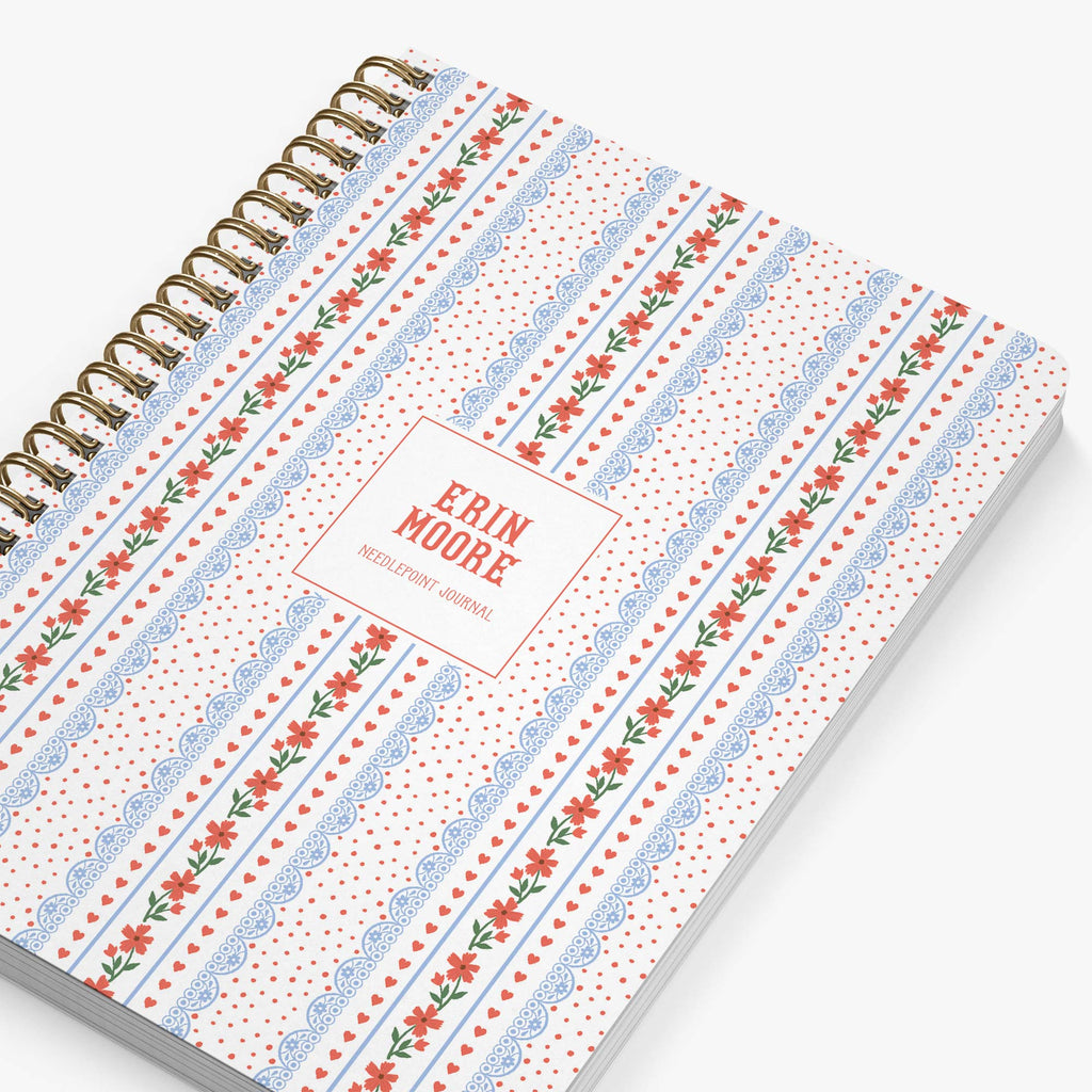 Personalized needlepoint journal with floral pattern in red, white and blue on a white background