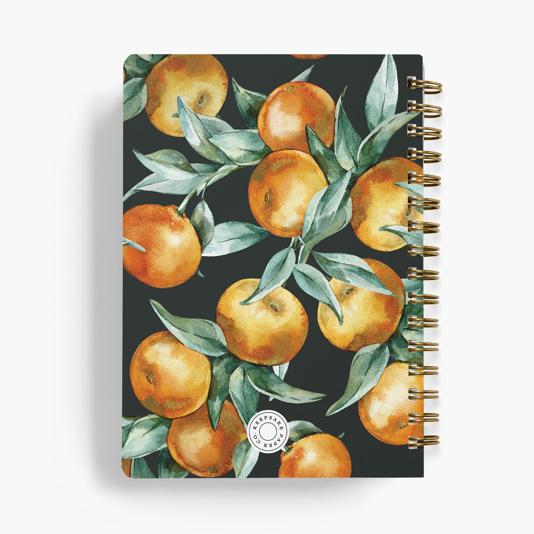 Personalized recipe notebook with orange and leaf pattern on a dark background