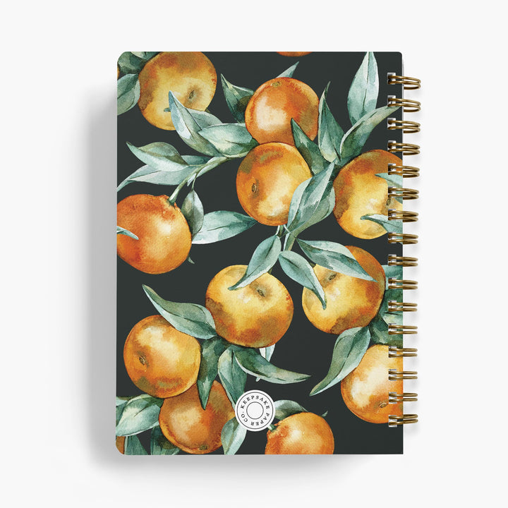 Personalized recipe notebook with orange and leaf pattern on a dark background