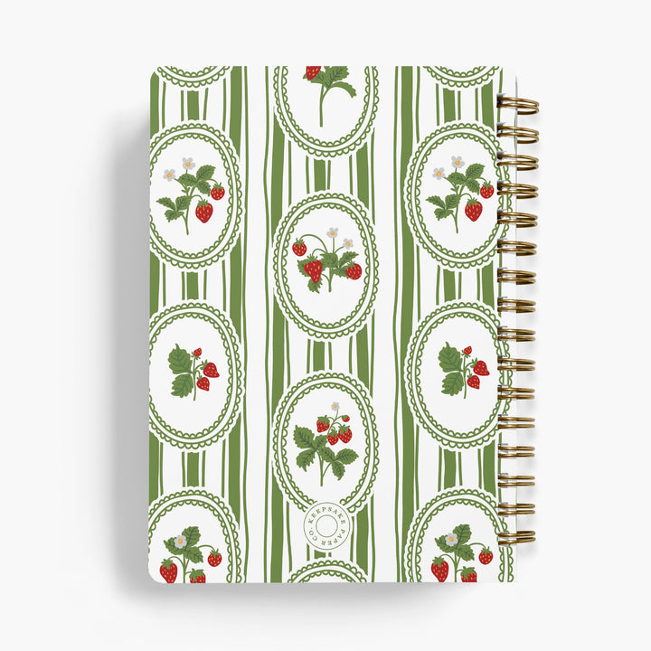 Custom cookbook with strawberry pattern on a white background