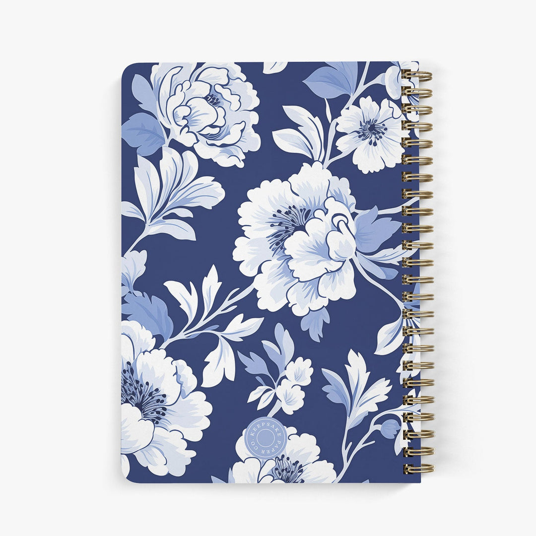Back view of personalized password notebook with blue and white toile-inspired pattern bound with gold wire