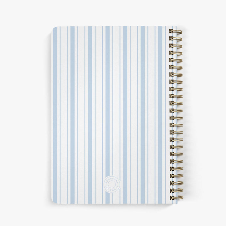Back view of custom address book with a nautically-inspired blue and white striped cover on a white background