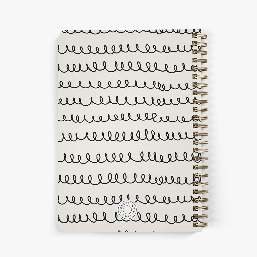 Back view of a personalized address notebook with whimsical squiggle design in black on a beige cover
