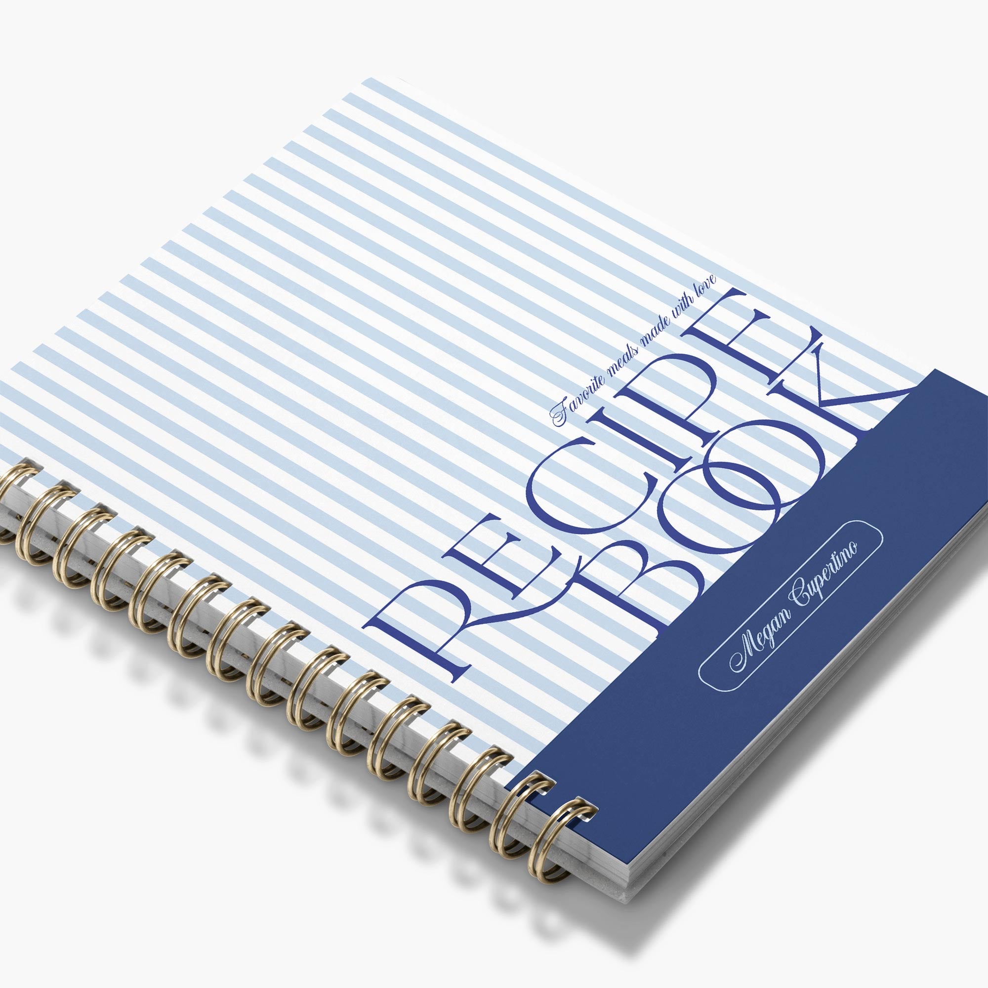 Custom cookbook in a blue and white stripe design with bold text and brass binding
