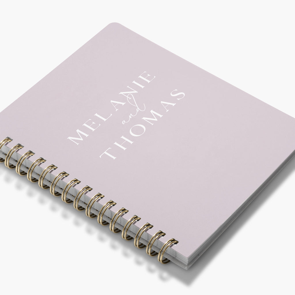 Custom wedding planner book with bride and groom's names on the cover on a white background