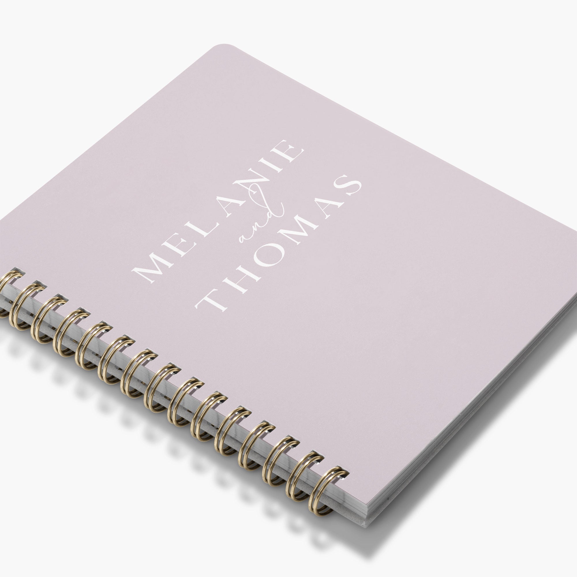 Custom wedding planner book with bride and groom's names on the cover on a white background