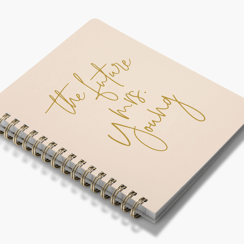 Custom wedding planning notebook with 'the future mrs.' in gold text on a white background