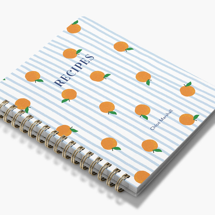 Recipe notebook with orange pattern on a white background
