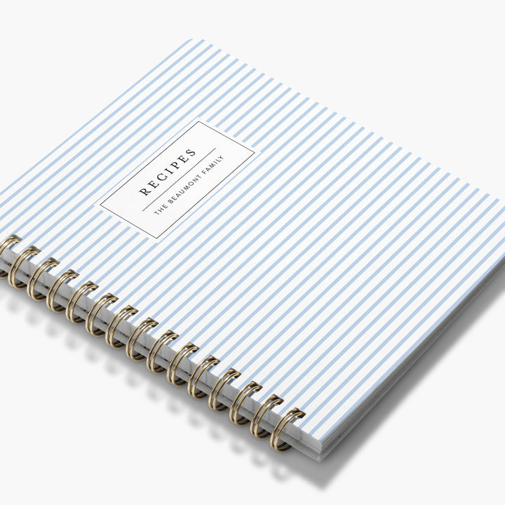 Custom cookbook with striped cover available in multiple colors with gold spiral binding